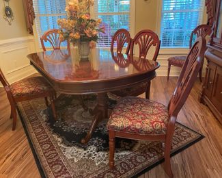wood dining sets, fabric dining chairs, area rug, brass wall art, china cabinet, curios