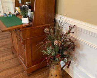 writing desk, silk flower arrangement, candles