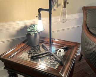 edison bulb table lamp, glass end table, metal accents, owl curios, green fabric armchair