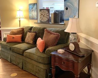 clocks, green sofa, coral throw pillows, brown throw pillows, blue oil painting canvas set