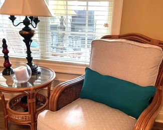 rattan armchair, beige pattern, turquoise throw pillows