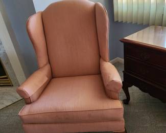 Rose colored wingback chair.