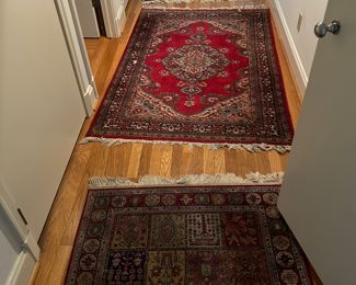 Foreground: Machine made Bakatar Design 4.9" x 3'.2" $100.,  Center: Tabriz Made in Pakistan 6' x 3' .8", Background: Indian Kashmir 7' x 4' Central Medallion Copy of a Mashad $350.