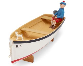 206
1998
An Aroutcheff "Tintin" Model Skiff
From the edition of about 300
Marked with applied sticker to underside of boat: © Moulinsart 1998
The polychrome wood and resin model of skiff with figurines of Herge's character Tintin and dog Snowy (Milou), depicted from the album "L'ile Noire," or, "The Black Island," sculpted by Patrick Regout for Michel Aroutcheff for the "Aroutcheff Tintin Vehicles" collection
With wood stand: 6.75" x 18.25" W x 6.125" D
Estimate: $1,000 - $2,000