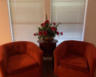 2 matching red swivel barrel chairs