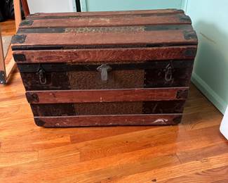 Antique arched-top steamer trunk with repousse floral and acorn panels, overall good condition 18"H x 30"W x 16"D