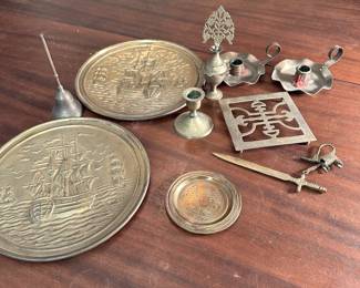 Brass and brass finished grouping of items including wall plaques, bell, perfume bottle and letter opener