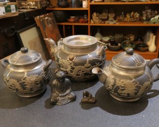 Black pottery tea service pieces with silver overlay