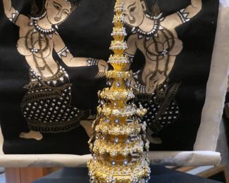 Thai ceremonial tree with sparkles. Black and gold dancers in the background