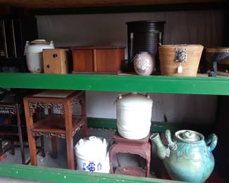 Large jugs, small accent furniture, tea basket with blue and white tea pot and tea bowls in the warehouse.