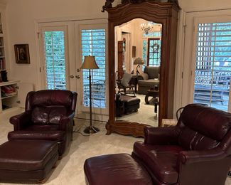 Pair of leather club chairs and ottomen