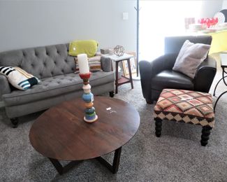 West Elm Stowe round table, another tufted loveseat and a dark brown Natuzzi leather chair