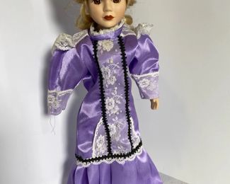 Blonde Porcelain doll with purple dress