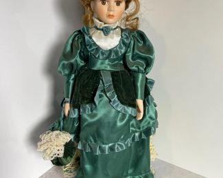 Redhair porcelain doll with green dress