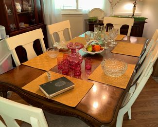 Dining table with over sized painted white chairs seats six to eight 
