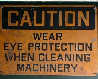 VINTAGE SIGN - “CAUTION WEAR EYE PROTECTION WHEN CLEANING MACHINERY”