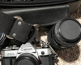 Canon 35mm camera with four lenses, carry case, and tripod
