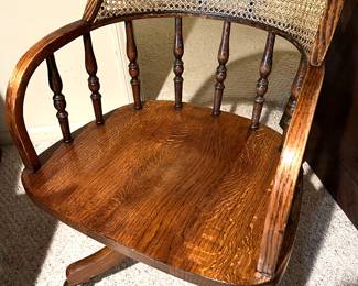 Vintage wooden desk chair with cane back and casters, looks great!