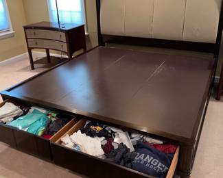 Beautiful bed with padded headboard and storage.