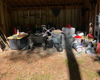 Oversized shed full of lawn equipment 