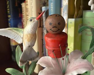 Little did our heroes know that their desperate cries were heard by none other than Happy Man! Happy Man was chilling with his happy hummingbird helpers just a few shelves away. Happy Man didn't like to hear such sad cries so away he went to help.