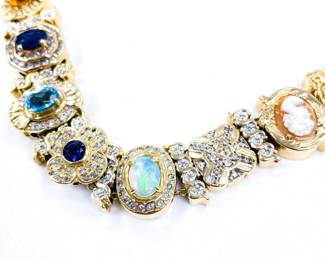 Richard Klein slide bracelet 14k yellow gold 33.39 dwt. Near mint condition. Set with Ruby, diamond, sapphire, emerald, amethyst, citrine, natural cameo, blue topaz, Opal, iolite, and rhodolite garnet.