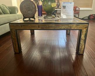 Drexel wood table with a beautiful black and gold design with a glass top.