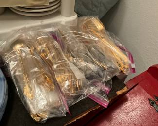 Gold tone silverware sets in kitchen 