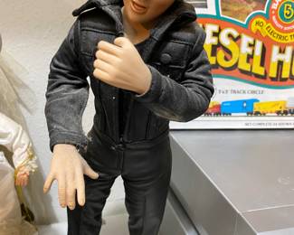 Front of Elvis doll on stand
