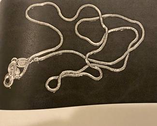 Woman’s 14 karat gold snake chain with large clasp weight approximately 6.8 g 18 inches long.