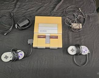https://www.auctionninja.com/hewitt-estates-and-antiques/product/vintage-super-nintendo-2-controllers-all-cords-included--300302.html