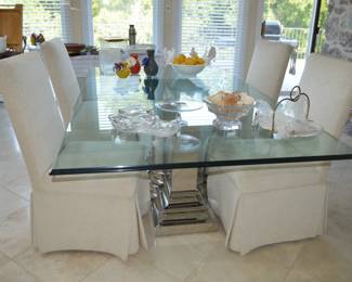 Glass dining room table with silver chrome pedestal base 