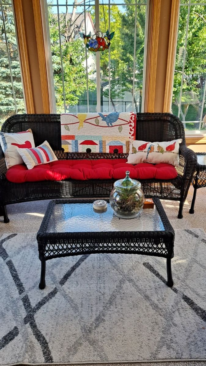 Black Wicker Furniture with Red Cushion; Coffee Table with Black Top; Lovely Bird Lap Top Quilt and Decorative Pillows; Hanging Stained Glass; Table Top Terrarium and much more!