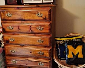 Broyhill Tall Boy Dresser; Small Wicker Chair; University of Michigan Items; Picture Frames; and Oversized Wall Frames for Family Photos.