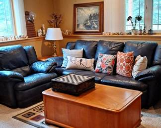Dark Navy Blue Leather Sofa and Matching Chair; Rabbit Collection; Lamp; Wood End Table; Painting / Artwork; Decorative Area Rugs; Chess / Checkerboard Set in Oriental Decorated Box with Drawer for Game Pieces; Oak Coffee Table with Storage; Decorative Pillows.
