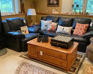 Nice Navy Blue Leather Sofa and Matching Chair; Decorative Pillow; Lamps; Wood Coffee Table with Storage Drawers and Cabinet; Decorative Chess / Checker Board; Assorted Rugs; Baskets and Rabbit Collectables.