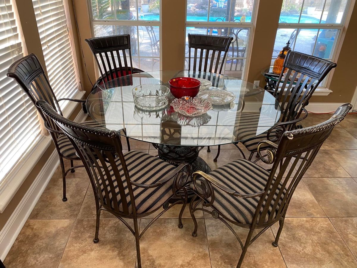 Glass Table & 6 Chairs
Table is in great shape
One of the chairs has been damaged from falling but is still usable.
Table: 54” across x 29” tall
Chairs: 22” across x 18” deep x 19” tall to seat, 40” tall to back. 
Must be able to move and load yourself