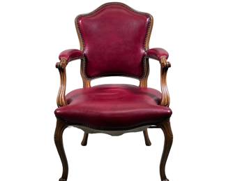 RED LEATHER ARMCHAIR | Carved wood and leather armchair with riveted border, rounded back and curved arms, and carved legs and feet. - l. 25 x w. 22.5 x h. 37.25 in
