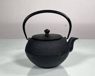 NAMBU STYLE JAPANESE IRONWARE TEAPOT | Small metal teapot with internal removable tea filter and beaded texture around the outside. Signed beneath spout. - h. 6.5 x dia. 5.5 in