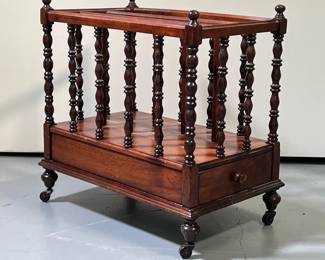VICTORIAN STYLE MAHOGANY CANTERBURY | Mahogany 3 slotted magazine organizer with spindle carved posts, small drawer on bottom and casters. - l. 20 x w. 12.75 x h. 20 in