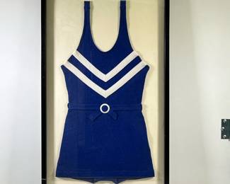 FRAMED ANTIQUE WOMAN’S BATHING SUIT | Navy blue with white stripes antique women’s bathing suit in large black frame. - l. 21.5 x h. 35.75 in