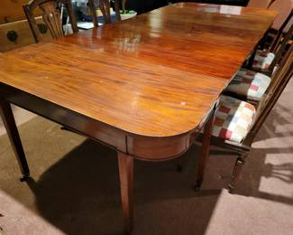 An antique extending Dining Table.