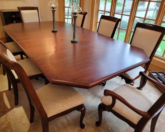A Mahogany Dining set with 8 chairs and extra table leaves. 