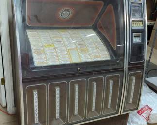 Rowe International Inc Phonograph Model R-82, Coin And Bill Operated, Includes 100 Records of Various Artists And Genres, Powers On, With Manual, 42"x26"x56"