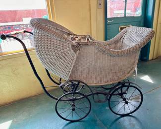 Antique white wicker and iron baby stroller.