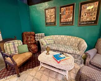 Furniture for sale including wall art and white wicker coffee table.