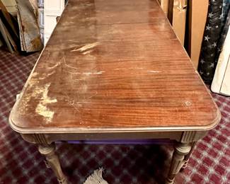 Antique dining table.  Solid but needs gentle hands to restore it to its original beauty.  See next picture for skirt and leg details.