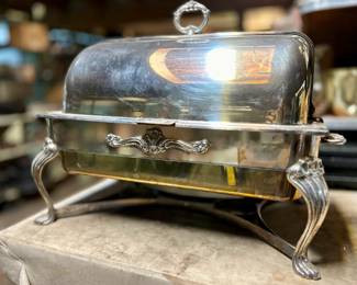 Silver chafing pan with hinged lid.
