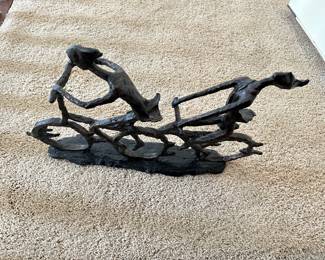 metal art people on bicycles