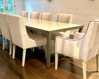 A Simply Done Design & Interiors Custom Designed One-Of-A-Kind Opaque Glass & Wood Dining Table. Measures 124" W x 41" D x 30" H with 28" Clearance. Shown With A Pair of Schumacher Upholstered Arm Chairs and A Set of 8 Simply Done Designed Dining Chairs Upholstered in Elitis Fabric. Photo 1 of 6. 